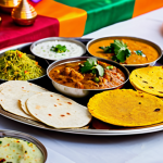 Festive Thali**

"A vibrant and colorful Indian Thali featuring various vegetarian dishes like dal, vegetables, rice, roti, raita, and sweets. The Thali is placed on a decorated table with Diwali lights in the background. Safe for work, appropriate content, fully clothed setting, professional food photography, family-friendly."

**